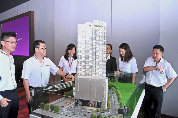 Gamuda Land The Robertson general manager Cheo Yuan Ping (left) and Ngan (second from left) looking at a model of The Robertson at the launch of the development’s new show gallery in Jalan Robertson, Kuala Lumpur.