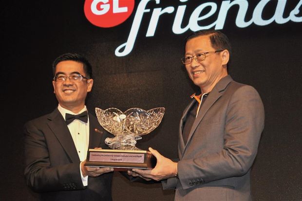 Mohammad Rashdan (left) presenting a token of appreciation to iPay88 co-founder Lim Kok Hing to mark Gamuda Land’s partnership with the payment gateway company which will enable housebuyers to settle progressive payments and maintenance fees online.